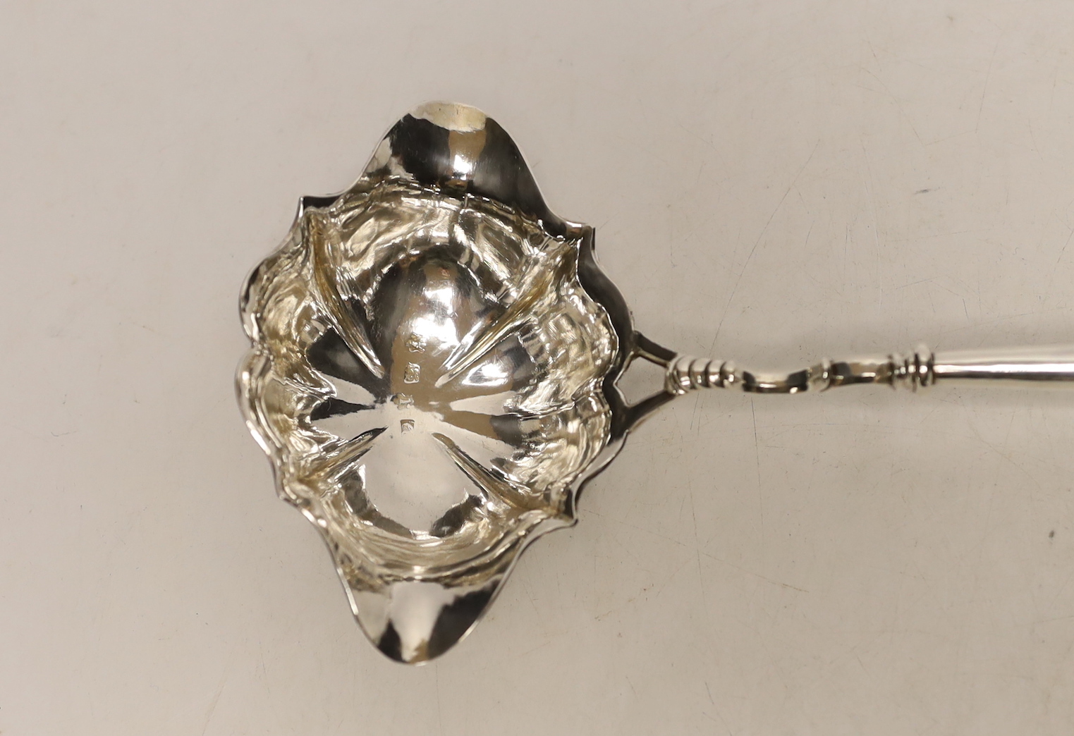 A George II silver toddy ladle, with turned wooden handle, London, 1752, 36.3cm.